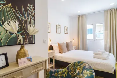 a hotel room with a bed and a desk with a chair at GuestReady – Quaint Retreat in Funchal in Funchal