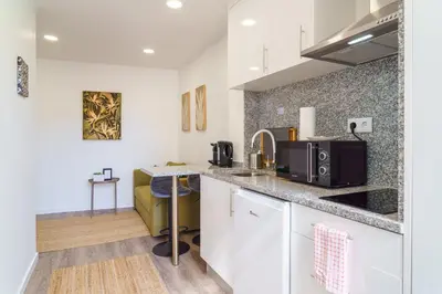 a kitchen with white cabinets and a counter top at GuestReady – Quaint Retreat in Funchal in Funchal