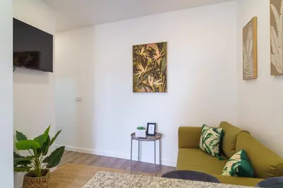 a living room with a green couch and a table at GuestReady – Quaint Retreat in Funchal in Funchal