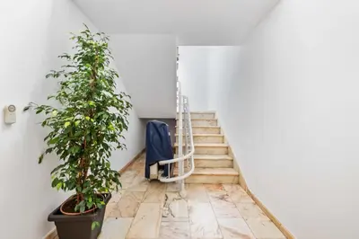 a staircase with a blue suitcase and a ladder at Casa dos Leões in Arco da Calheta