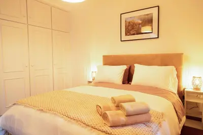 a bedroom with a bed with two towels on it at Villa Rita in Machico in Machico