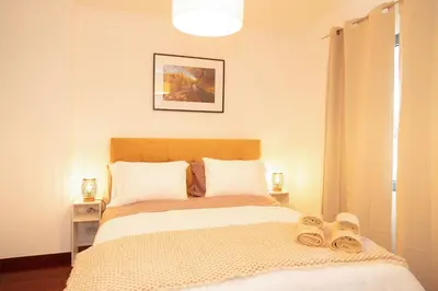 a bedroom with a bed with two slippers on it at Villa Rita in Machico in Machico