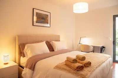 a bedroom with a bed with towels on it at Villa Rita in Machico in Machico