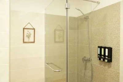 a shower with a glass door in a bathroom at Villa Rita in Machico in Machico