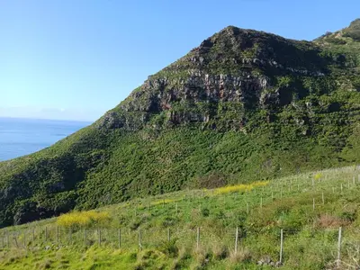 a mountain with a fence on the side of it at Sao Lourenco in Caniçal