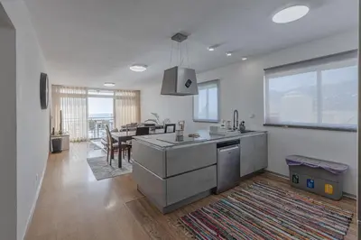 a kitchen and dining room with a dining table at flowers island house 8 infinity in Funchal