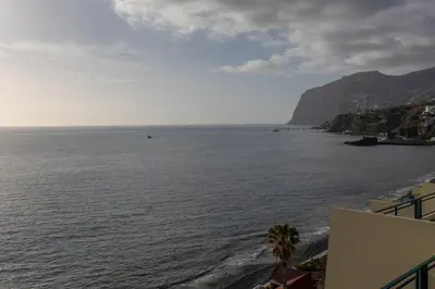 a view of a body of water with a mountain at flowers island house 8 infinity in Funchal