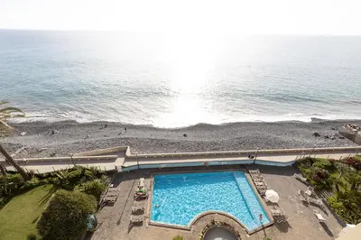 an overhead view of a swimming pool next to a beach at flowers island house 8 infinity in Funchal