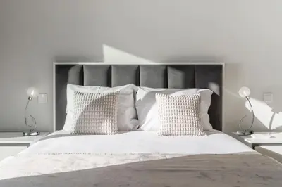a white bedroom with a large bed with white pillows at Saraiva Hills I by An Island Apart in Câmara de Lobos