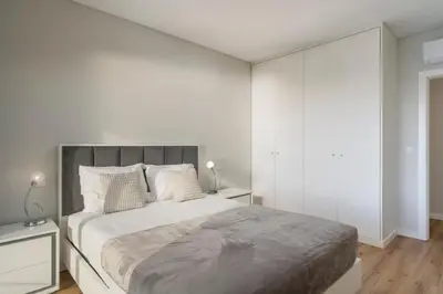 a white bedroom with a large bed and white walls at Saraiva Hills I by An Island Apart in Câmara de Lobos