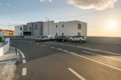 a parking lot with cars parked in front of a building at Saraiva Hills I by An Island Apart in Câmara de Lobos