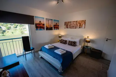 a bedroom with a bed and a balcony at SkyView Penthouse Apartment in Caniço