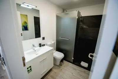 a bathroom with a toilet and a sink and a shower at SkyView Penthouse Apartment in Caniço