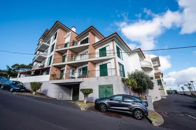 a car parked in front of a building at SkyView Penthouse Apartment in Caniço