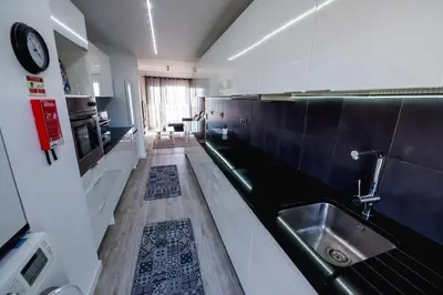 a kitchen with a sink and a counter top at SkyView Penthouse Apartment in Caniço