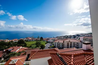 a view of a town with the ocean in the background at SkyView Penthouse Apartment in Caniço