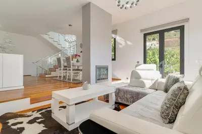 a living room with a white couch and a table at Countryside Charm House by Holiday Rental Madeira in Câmara de Lobos