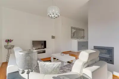 a living room with white furniture and a chandelier at Countryside Charm House by Holiday Rental Madeira in Câmara de Lobos