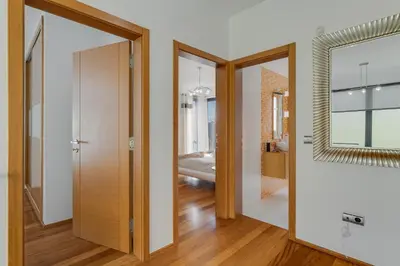 a hallway with two doors and a mirror at Countryside Charm House by Holiday Rental Madeira in Câmara de Lobos