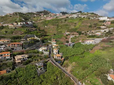 an aerial view of a village on a hill at Countryside Charm House by Holiday Rental Madeira in Câmara de Lobos
