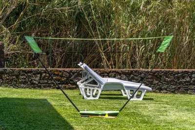 a swing in the grass in a yard at villa vista do vale in São Vicente