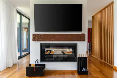 a living room with a fireplace with a flat screen tv at villa vista do vale in São Vicente