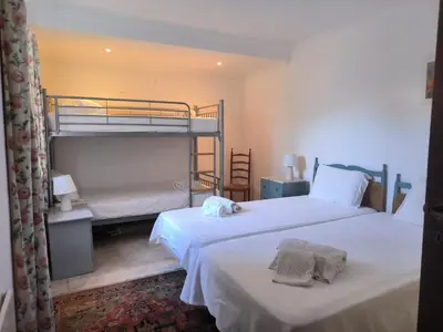 two beds in a room with two bunk beds at Luz Bay Club 29 in Luz