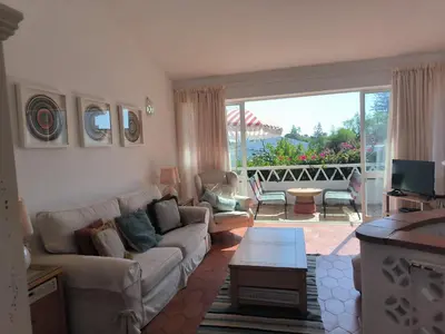 a living room with a couch and a table at Luz Bay Club 29 in Luz