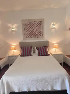 a bedroom with a large white bed with two lamps at Luz Bay Club 29 in Luz