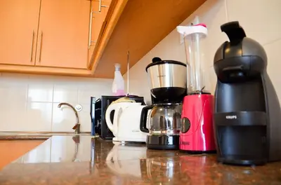 a kitchen counter with a blender and other appliances at Teixeira House in Arco da Calheta
