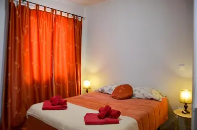 a bedroom with a bed with red towels on it at Teixeira House in Arco da Calheta