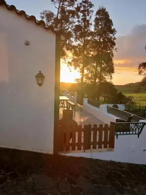 a white house with green windows and a balcony at Casa da VíVí in Azenha de Baixo