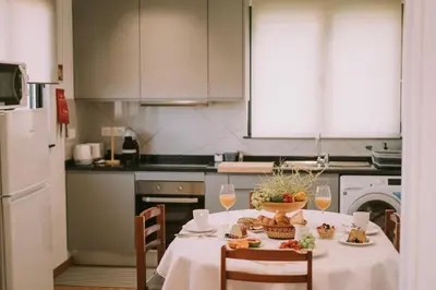 a kitchen with a table with glasses of wine at Bela Vista House in Ponta Delgada