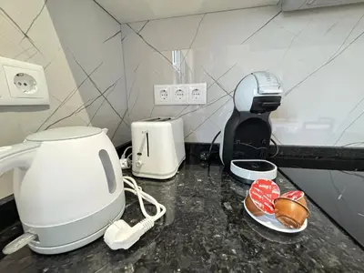 a kitchen counter with a coffee maker and a toaster at Bela Vista House in Ponta Delgada