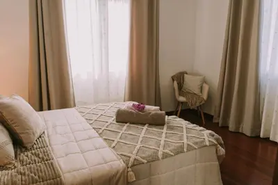 a bedroom with a bed with a stuffed animal on it at Bela Vista House in Ponta Delgada