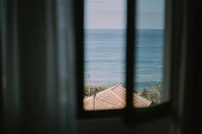 a view of the ocean from a window at Bela Vista House in Ponta Delgada