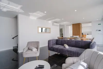 a living room with a couch and two chairs at GuestReady - Madeiran oasis with ocean view in Campanário