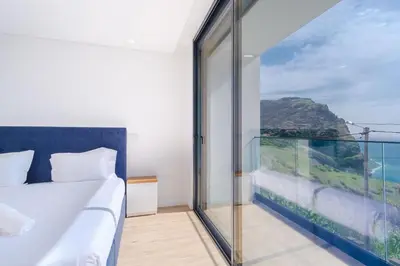 a bedroom with a bed and a view of the ocean at GuestReady - Madeiran oasis with ocean view in Campanário