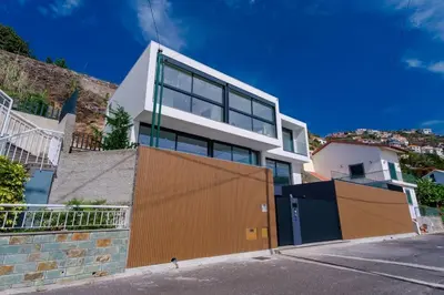 a house with an orange and white at GuestReady - Madeiran oasis with ocean view in Campanário