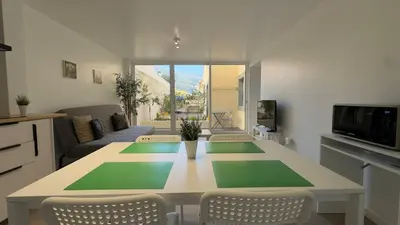 a living room with a table with green mats on it at Like Home IV - Ideal for families and friends in Funchal