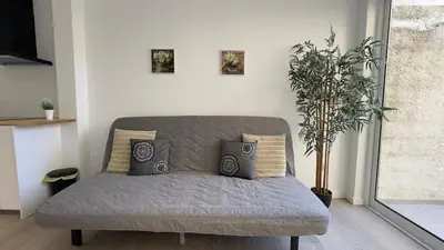a gray couch in a living room with a plant at Like Home IV - Ideal for families and friends in Funchal