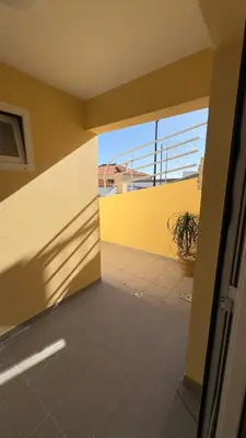 an empty room with a yellow wall and a patio at Like Home IV - Ideal for families and friends in Funchal