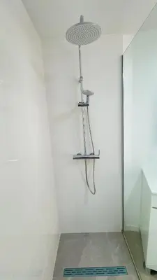 a shower in a white wall with a shower head at Like Home IV - Ideal for families and friends in Funchal