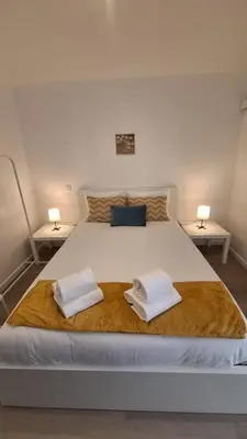 a bedroom with a bed with two towels on it at Like Home V - single room in Funchal