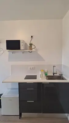 a kitchen with a counter with a sink and a microwave at Like Home V - single room in Funchal