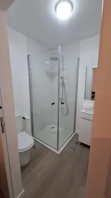 a bathroom with a glass shower and a toilet at Like Home V - single room in Funchal