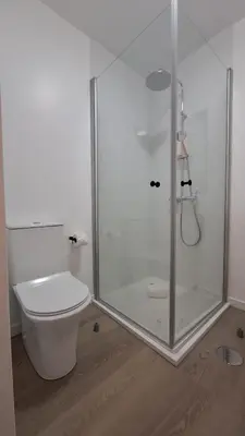 a bathroom with a toilet and a glass shower at Like Home V - single room in Funchal