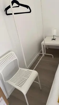 a white chair and a table in a room at Like Home V - single room in Funchal