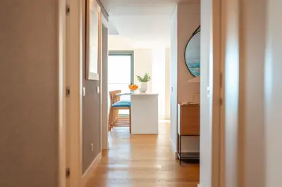 a hallway with a room with a table and a table at Suite 5P Madeira Acqua Residence in Funchal