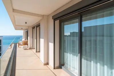 a balcony of a building with a view of the ocean at Suite 5P Madeira Acqua Residence in Funchal